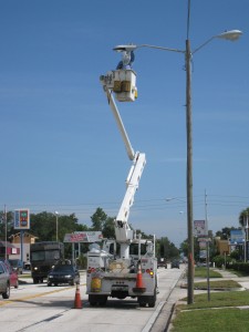 A utility crew performing maintenance on a streetlight requires a temporary work zone.