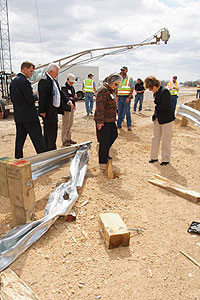 Chancellor Mike McKinney and others observe the demolished guardrail following the crash test.