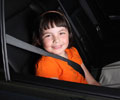 child wearing a seatbelt in a car