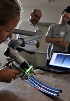 Hillary-Anne Metcalfe measuring a component using the FARO arm.