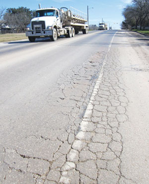 oil truck traffic on a damaged roadway