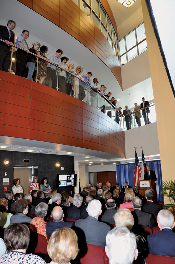 Employees gathered around to hear TTI employees and invited guests gather around to hear TTI Director Dennis Christiansen's remarks during the grand opening celebration of TTI's building.