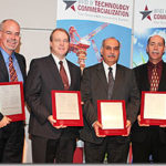 Holding their Patent and Innovation Awards (from L to R) are Dean Alberson, Roger Bligh, Akram Abu-Odeh, Lance Bullard and Gene Buth. They are flanked by Chancellor Mike McKinney on the left and OTC's Brent Cornwell on the right.