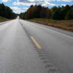Highway with inverted rumble strips