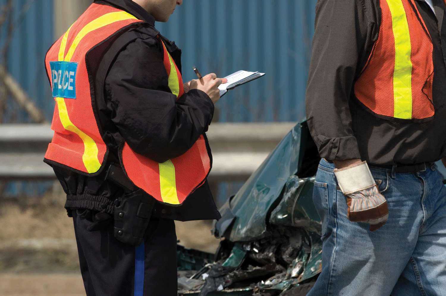 Officer writing a ticket at a crash scene