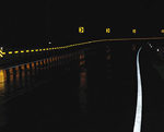 nighttime photo of reflective pavement markings on roadway