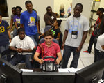 Summer Transportation Institute students watching a driving simulator demonstration.