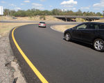 Recently paved curve on highway.