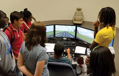 Prairie View A&M University's Summer Transportation Institute group tours TTI's driving simulator