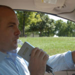A driver blowing into an ignition interlock device.