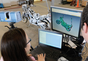Researchers use a 3-D scanning device, called a FARO Edge, to scan each individual part of a motorcycle.