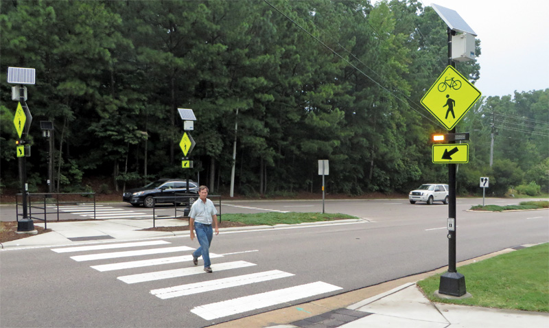 Pedestrian crossing road traffic sign showing a person on a zebra