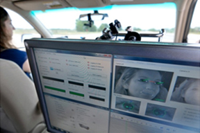 computer mounted behind passenger seat to monitor eye tracking equipment