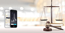 smart phones with the Uber app displayed next to scales and a gavel