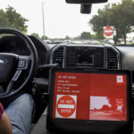 A driver display indicating a "wrong way driver" inside a TTI test vehicle.