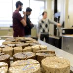 Workers test samples inside the soil/unbound materials innovation lab.