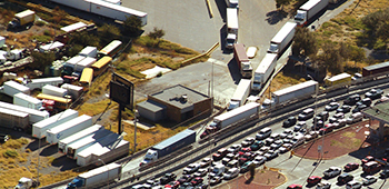 aerial view of vehicle and truck traffic at a border crossing
