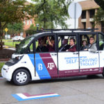 Texas A&M officials join Dr. Srikanth Saripalli to ride the first autonomous shuttle in service in downtown Bryan, Texas.