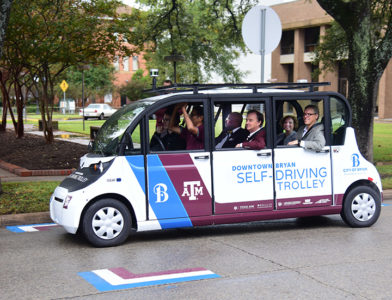 Texas A&M officials join Dr. Srikanth Saripalli to ride the first autonomous shuttle in service in downtown Bryan, Texas.
