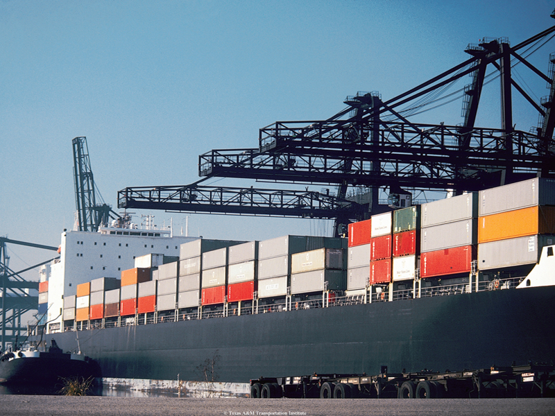 A container ship with freight containers stacked on deck.