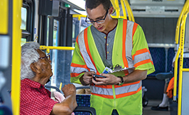 Transit bus customer participating in a survey while riding the bus.