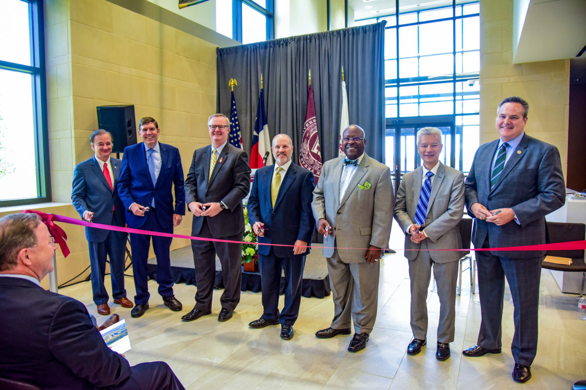 Speakers cutting the ribbon at the ribbon cutting ceremony of the TTI State Headquarters Building.