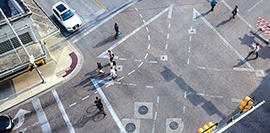 Photograph of a diagonal crosswalk taken from a rooftop.