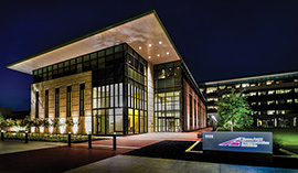 Photograph of the TTI Headquarters building taken at nighttime.