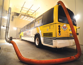 Vehicle emissions of a transit bus being measured during testing inside the Environmental and Emissions Research Facility's drive-in environmental chamber.