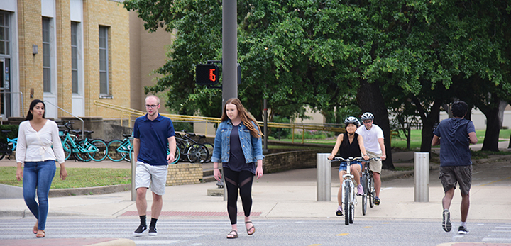 Bicyclists and pedestrians using a crosswalk.
