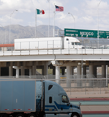 18-wheeler truck traffic near a U.S.-Mexico border crossing.