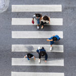 Aerial view of pedestrians using a crosswalk.