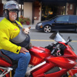 A photo of TTI Agency Director Greg Winfree on his motorcycle with his dog, Maya.