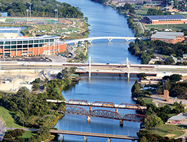 Aerial view over an urban area showing several bridges crossing a river.