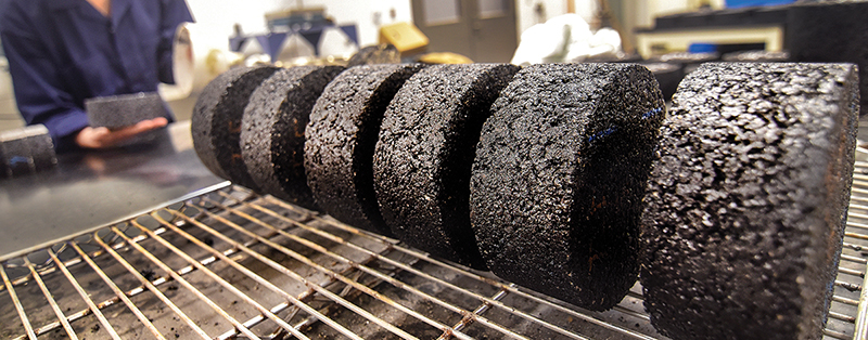 Asphalt core samples on a rack.