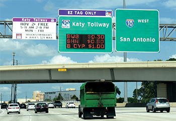 Katy Freeway toll lanes (I-10) in Houston, Texas showing overhead signage displaying dynamic toll rates.
