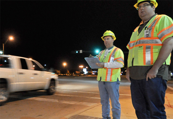 TTI researchers conducting a traffic survey at night.