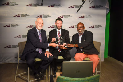 TTI's Robert Wunderlich, Raul Avelar, and Greg Winfree hold the 2021 National Roadway Safety Award during the virtual awards ceremony hosted by the Roadway Safety Foundation.