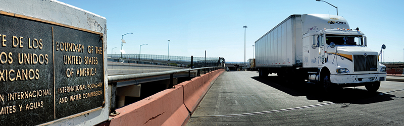 An 18-wheeler passing through a U.S-Mexico border crossing.