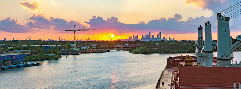 Photograph taken from a ship in the Port of Houston looking toward downtown Houston at sunset.
