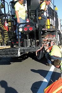 Modern day pavement striping equipment in use on a roadway.