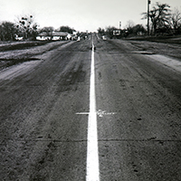 Historical photo of a newly striped two-lane highway.