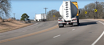 Truck traffic on a rural, 4-lane, undivided highway.