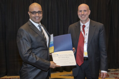 Texas A&M Transportation Institute's Sushant Sharma accepts the Blue Ribbon Award in Implementation on behalf of the Freight Planning and Logistics Committee.