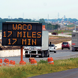 Changeable message sign announcing a 17 minute drive time for a 17 mile stretch of roadway being worked on as part of the I-35 Waco project.
