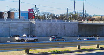 Photograph of a retaining wall showing how a portion of it was extended to accommodate a utility duct bank that was shallower than previously thought.