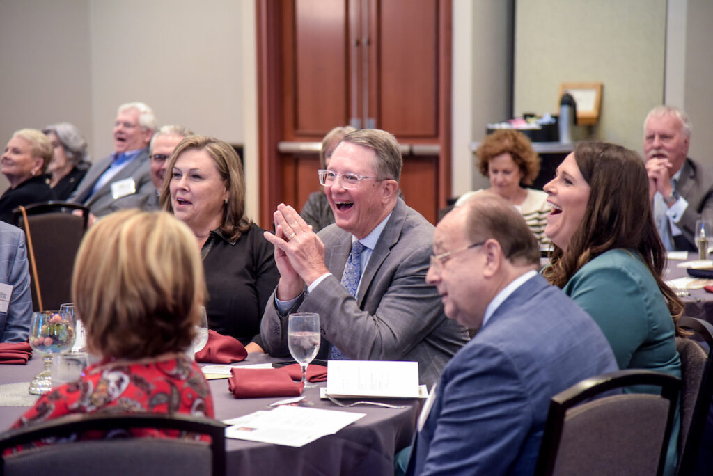 Gary Thomas and others applauding one of the speakers at Gary's retirement event.