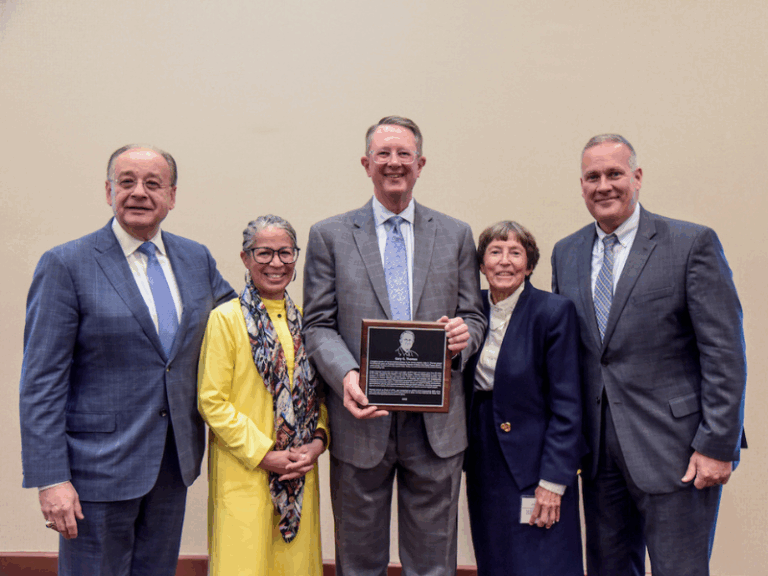 Photo of Gary Thomas holding his Hall of Honor plaque.