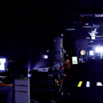 Visibility Laboratory during a test. Various traffic signs, lights, and reflective materials are set up with researchers seated at a monitoring station to the side.