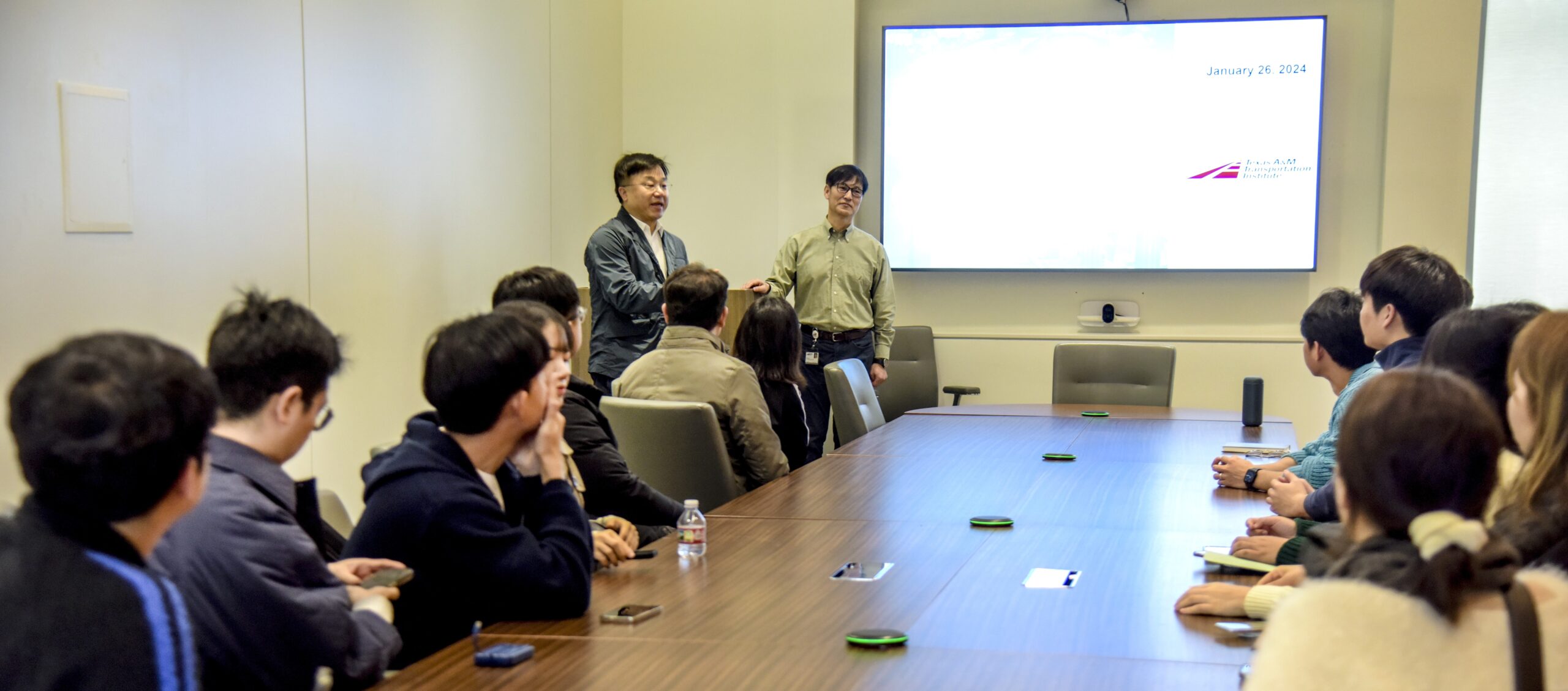 Visitors from the KAIST Program gather around a meeting table at the Texas A&M Transportation Institute headquarters building.